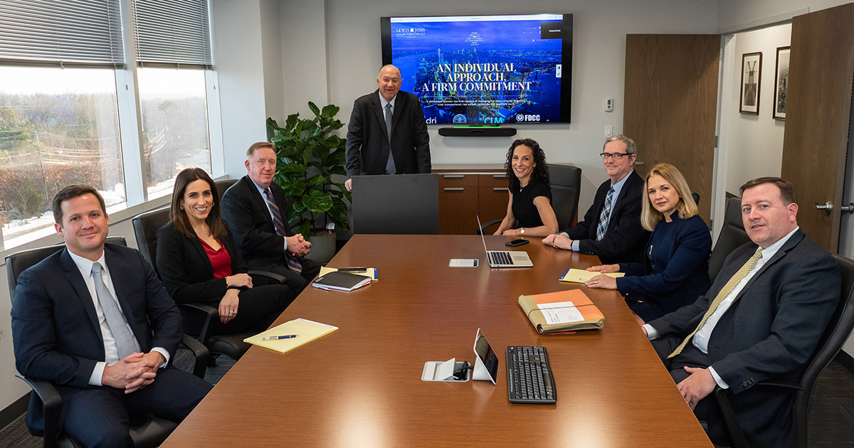 The Lewis Johs team seated at a conference table