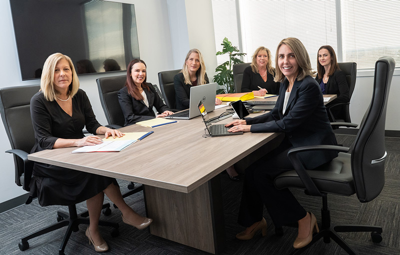 Lewis Johs diverse attorneys seated at a conference room table